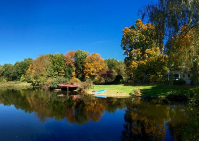 Panorama of Pond & House in Fall.
